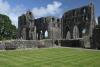 A view of the main ruins of Dundrennan Abbey on a sunny day