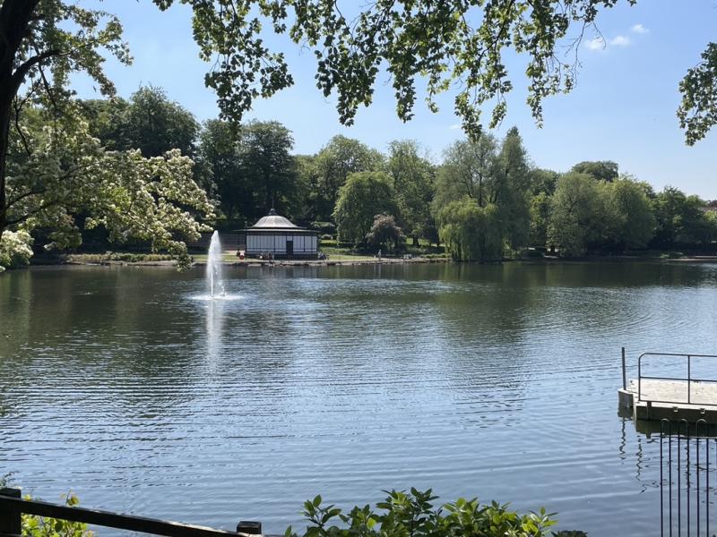 View across a lake to the bandstand